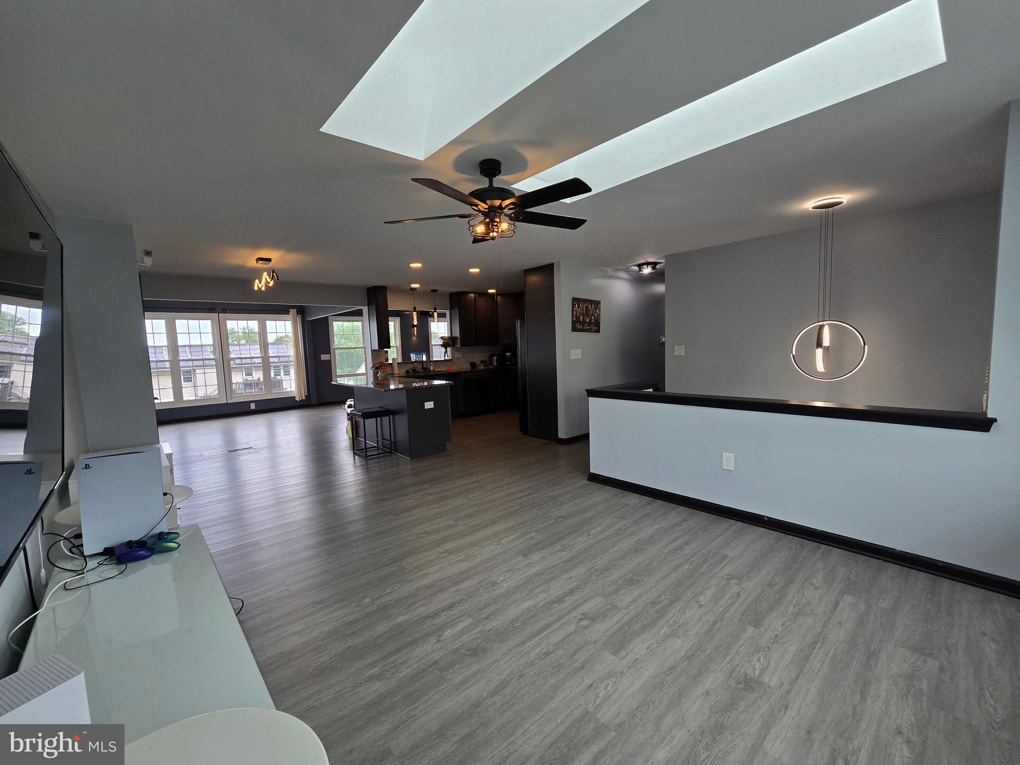 7513 Saffron Court Hanover, MD 21076 - Photo 6 of 42 a living room with couches and kitchen view with wooden floor