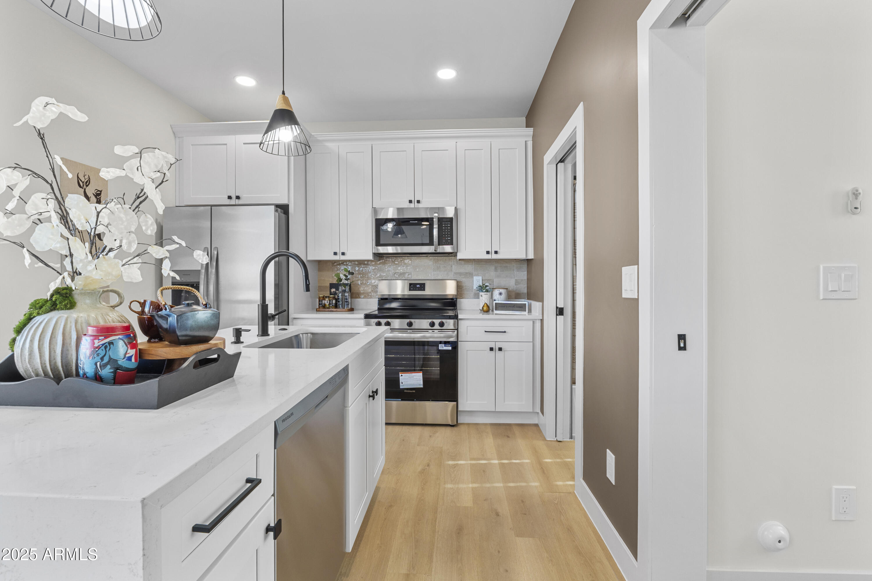 1502 South 14th Street Phoenix, AZ 85034 - Photo 11 of 43 a kitchen with kitchen island white cabinets and refrigerator