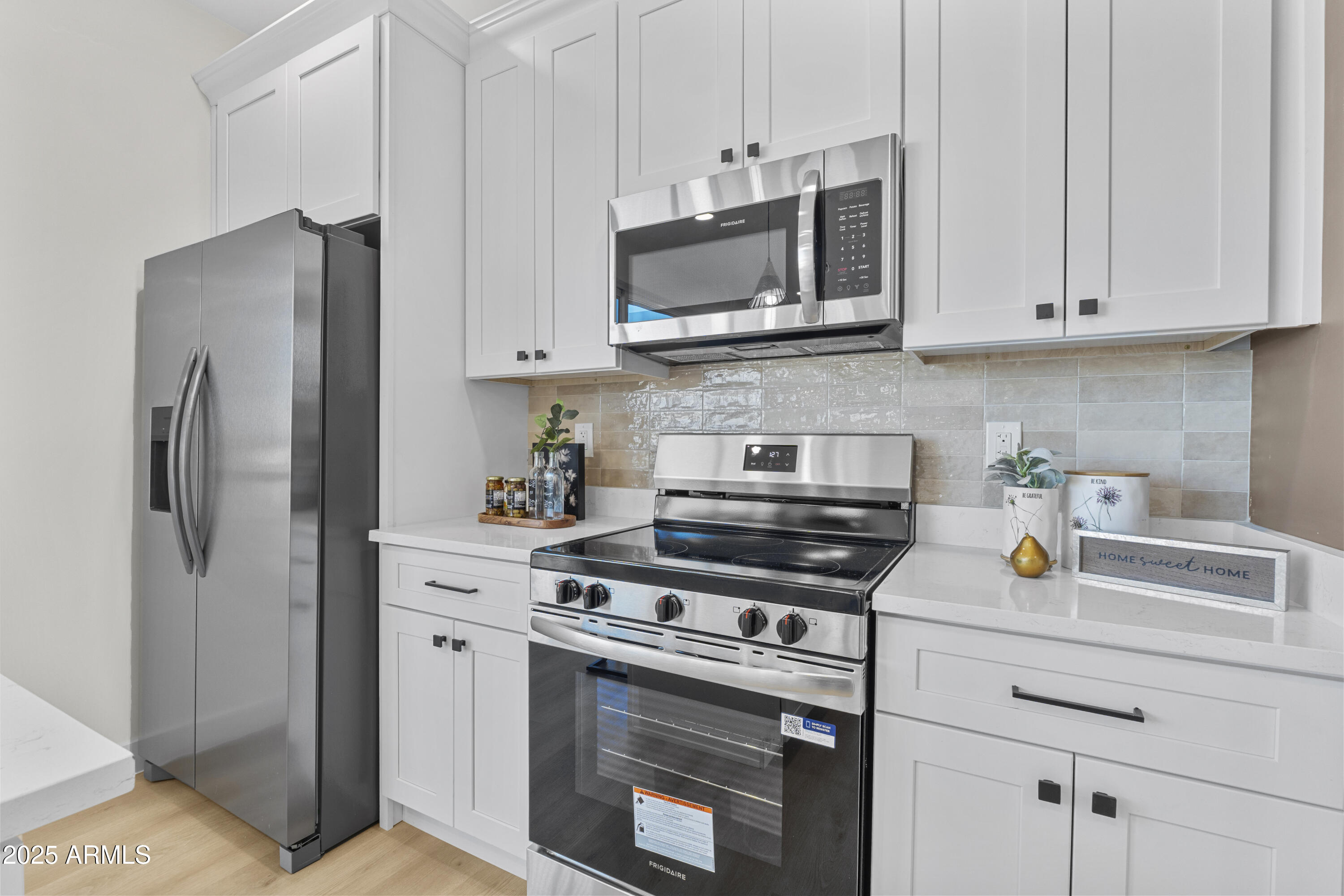 1502 South 14th Street Phoenix, AZ 85034 - Photo 12 of 43 a kitchen with stainless steel appliances white cabinets and a stove