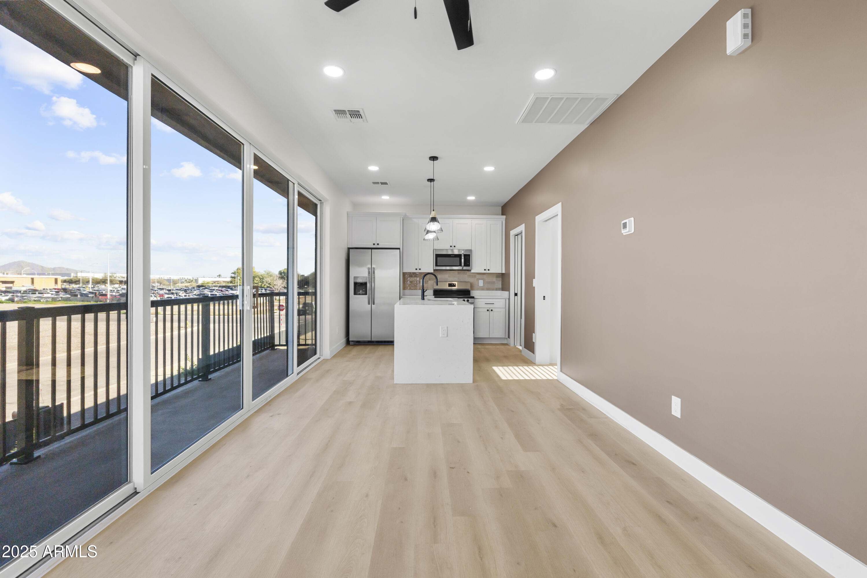 1502 South 14th Street Phoenix, AZ 85034 - Photo 24 of 43 a view of a kitchen with kitchen island wooden floors stainless steel appliances and windows
