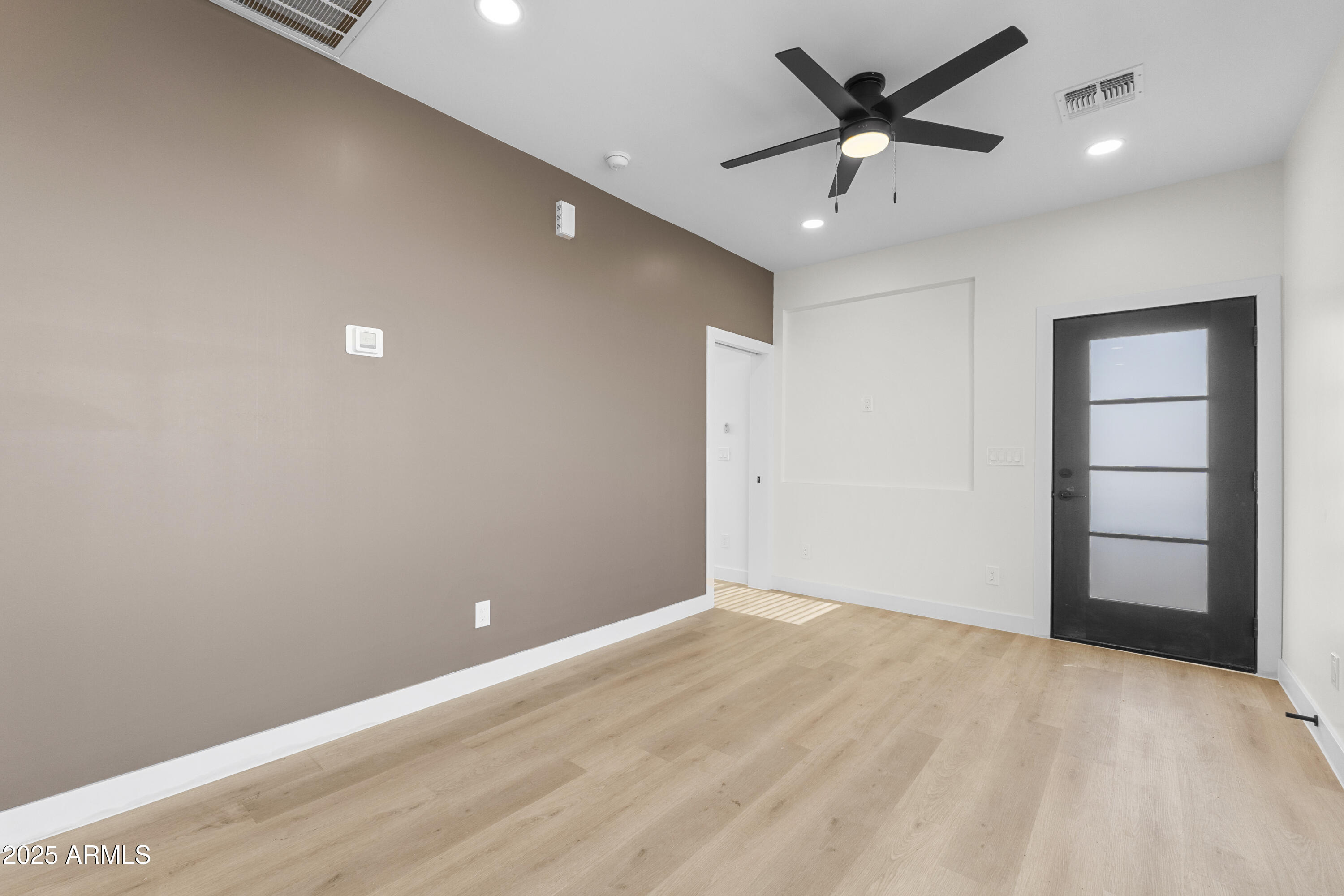 1502 South 14th Street Phoenix, AZ 85034 - Photo 27 of 43 a view of a big room with wooden floor and a ceiling fan