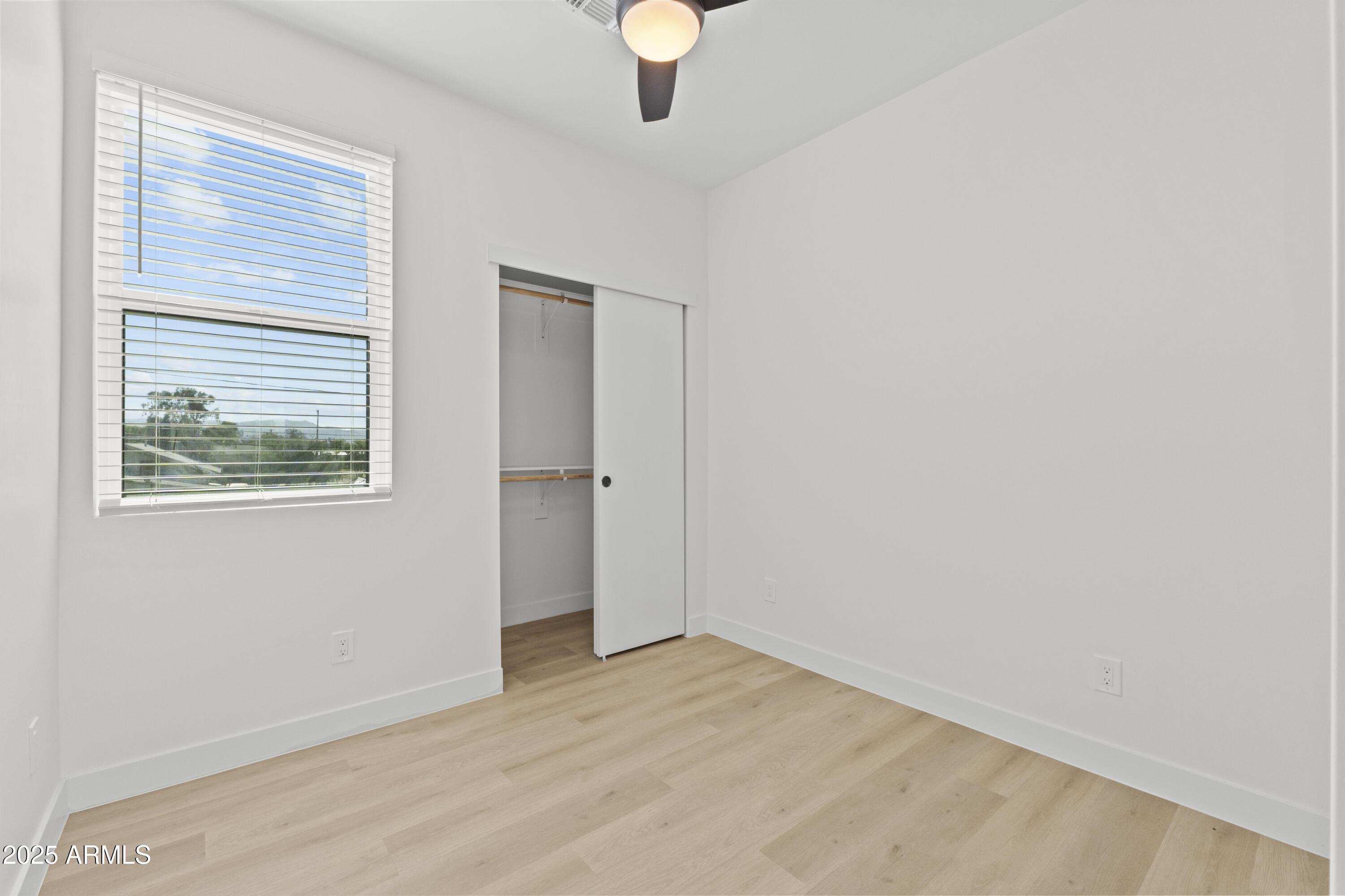 1502 South 14th Street Phoenix, AZ 85034 - Photo 36 of 43 a view of an empty room with window and wooden floor