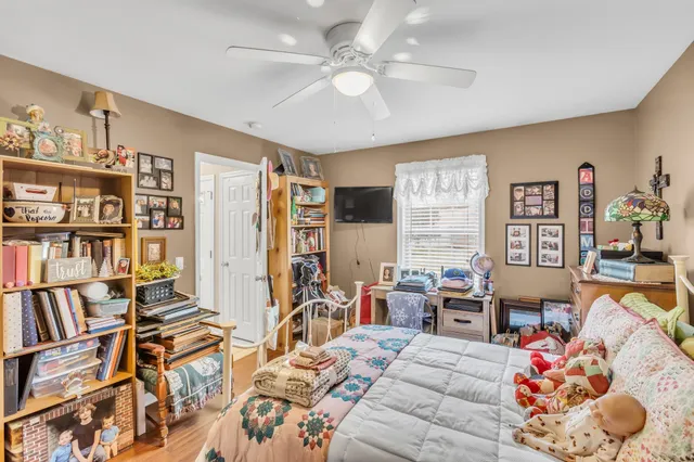 a bedroom with furniture and a book shelf