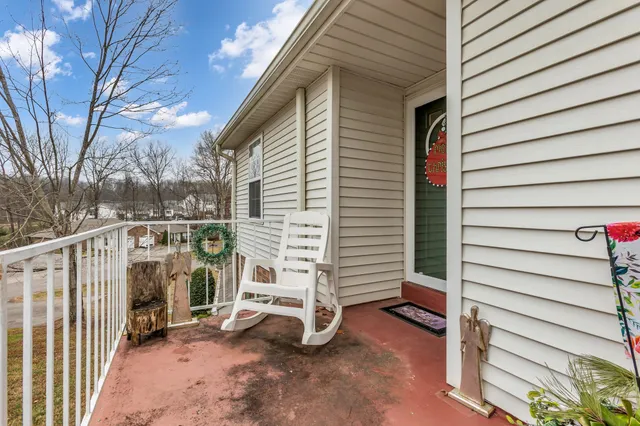 a view of a house with a door and wooden fence