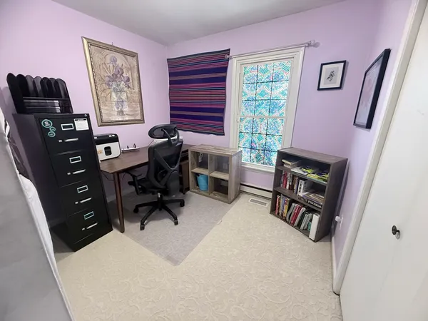 a view of livingroom with furniture and a book shelf