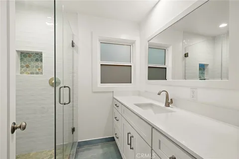 a bathroom with a granite countertop mirror