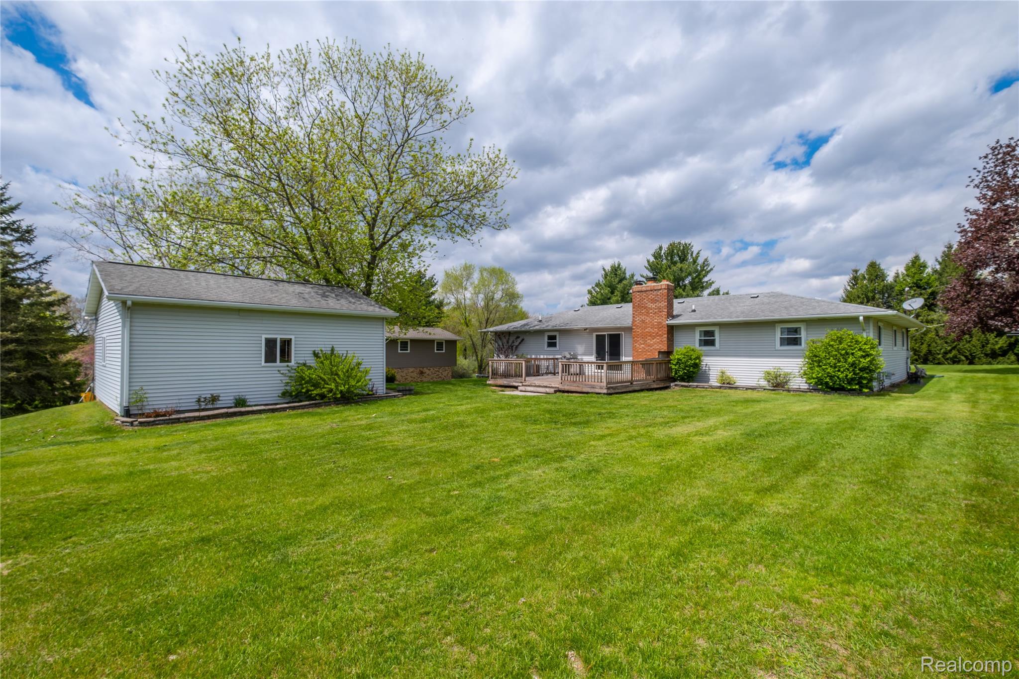 11430 Silver Lake Road Byron, MI 48418 - Photo 21 of 32 Rear view of house with a wooden deck and a lawn