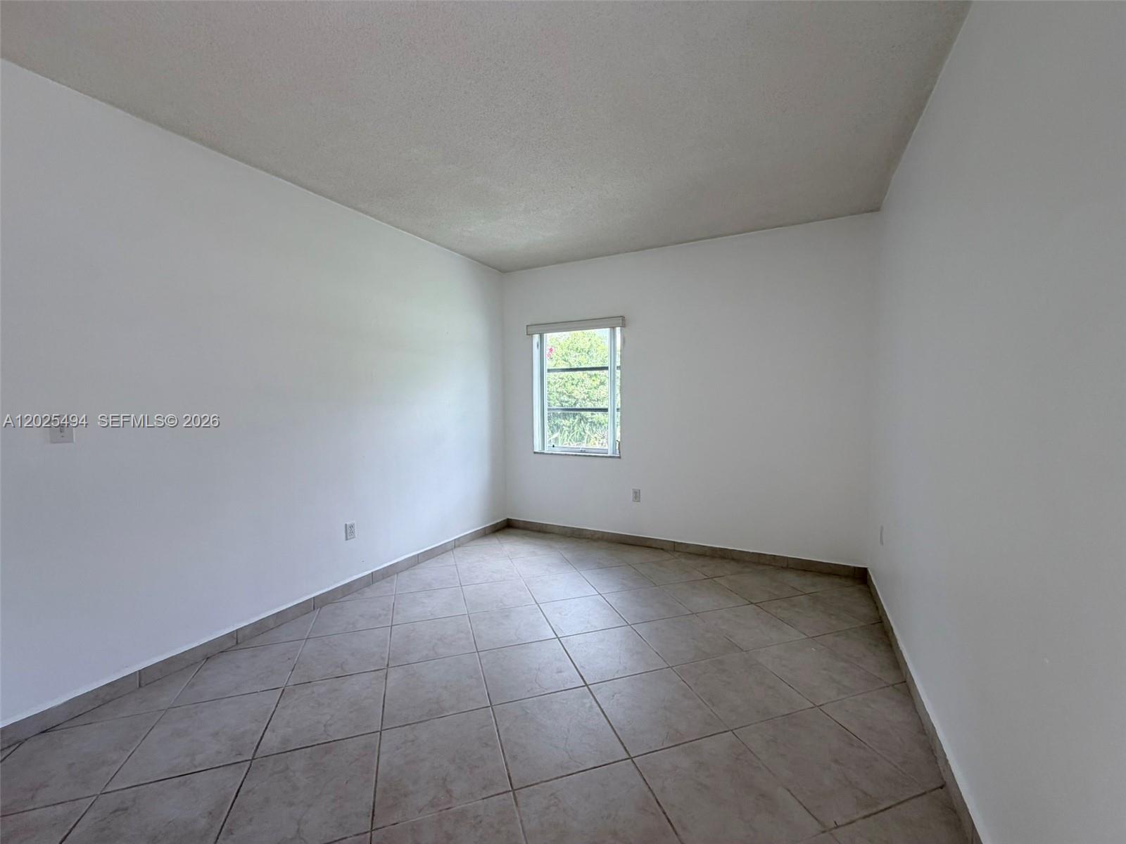 9159 Southwest 77th Avenue, Unit 112 Miami, FL 33156 - Photo 24 of 38 a view of an empty room with a window