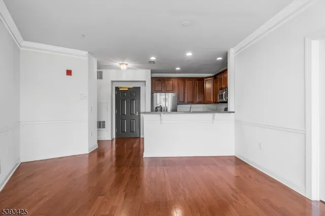 a view of a kitchen with a sink and a refrigerator