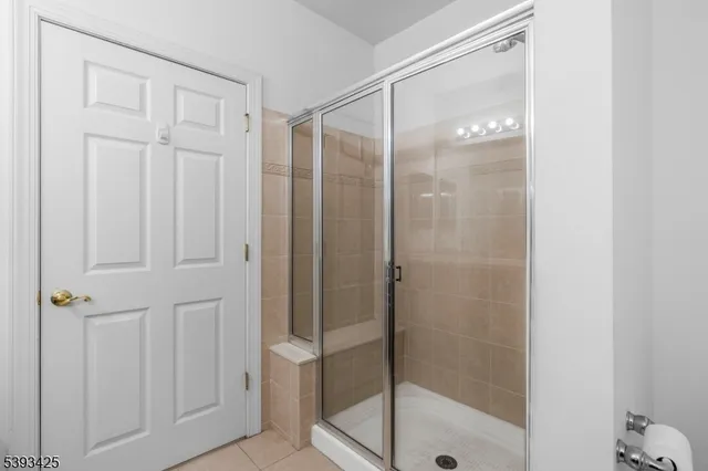 a bathroom with a glass shower door