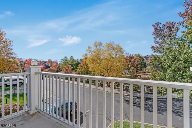 a balcony with wooden floor and fence