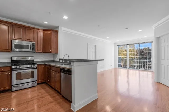 a kitchen with stainless steel appliances granite countertop a stove and a sink