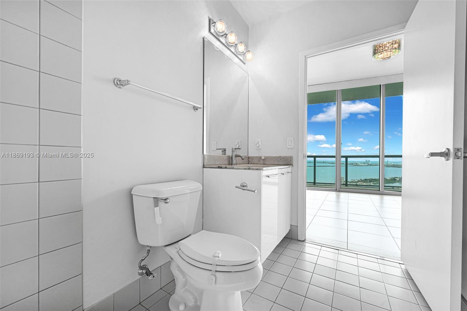 888 Biscayne Boulevard, Unit 5010 Miami, FL 33132 - Photo 11 of 18 a white toilet sitting next to a bathroom sink