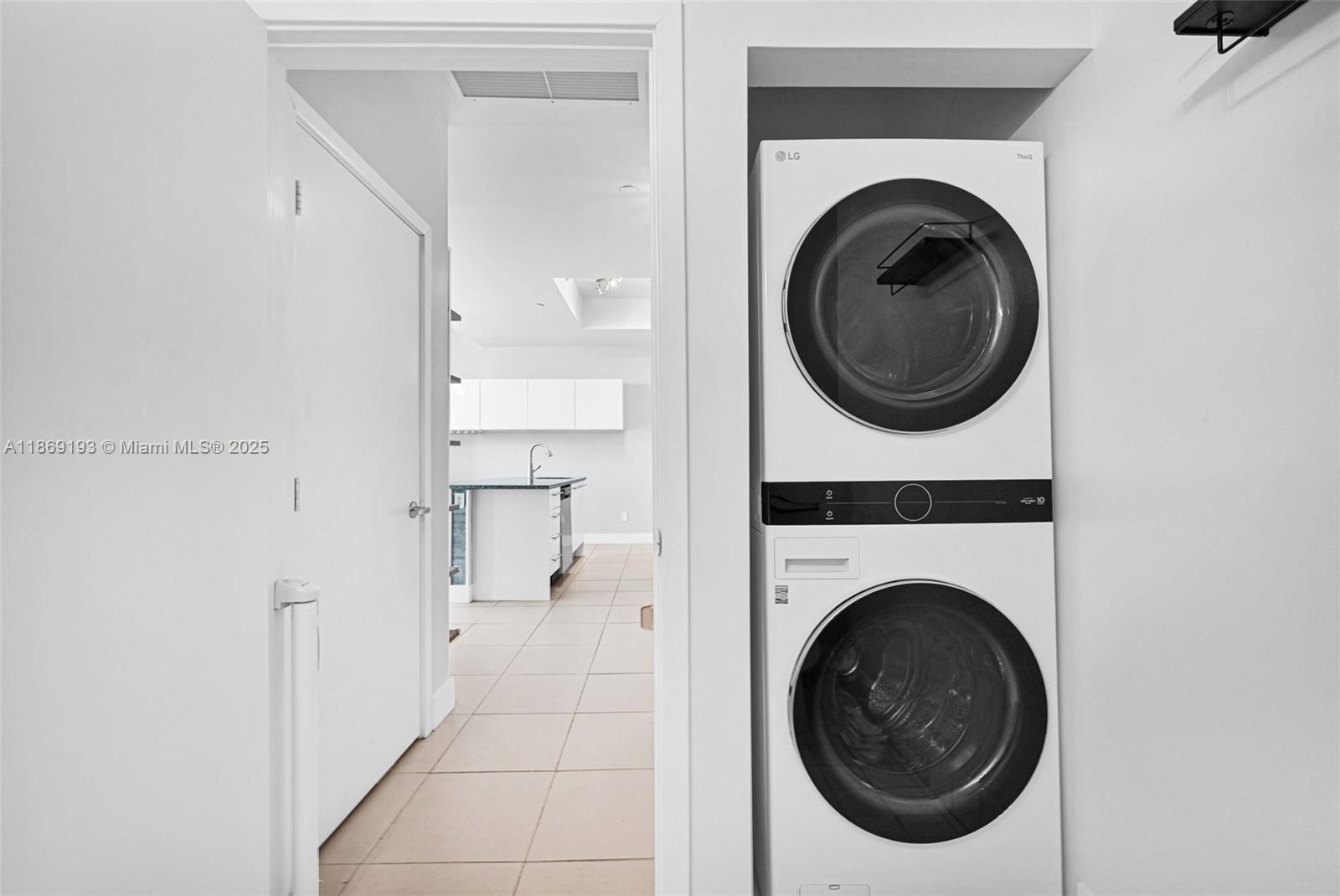 888 Biscayne Boulevard, Unit 5010 Miami, FL 33132 - Photo 13 of 18 a view of a hallway with washer and dryer