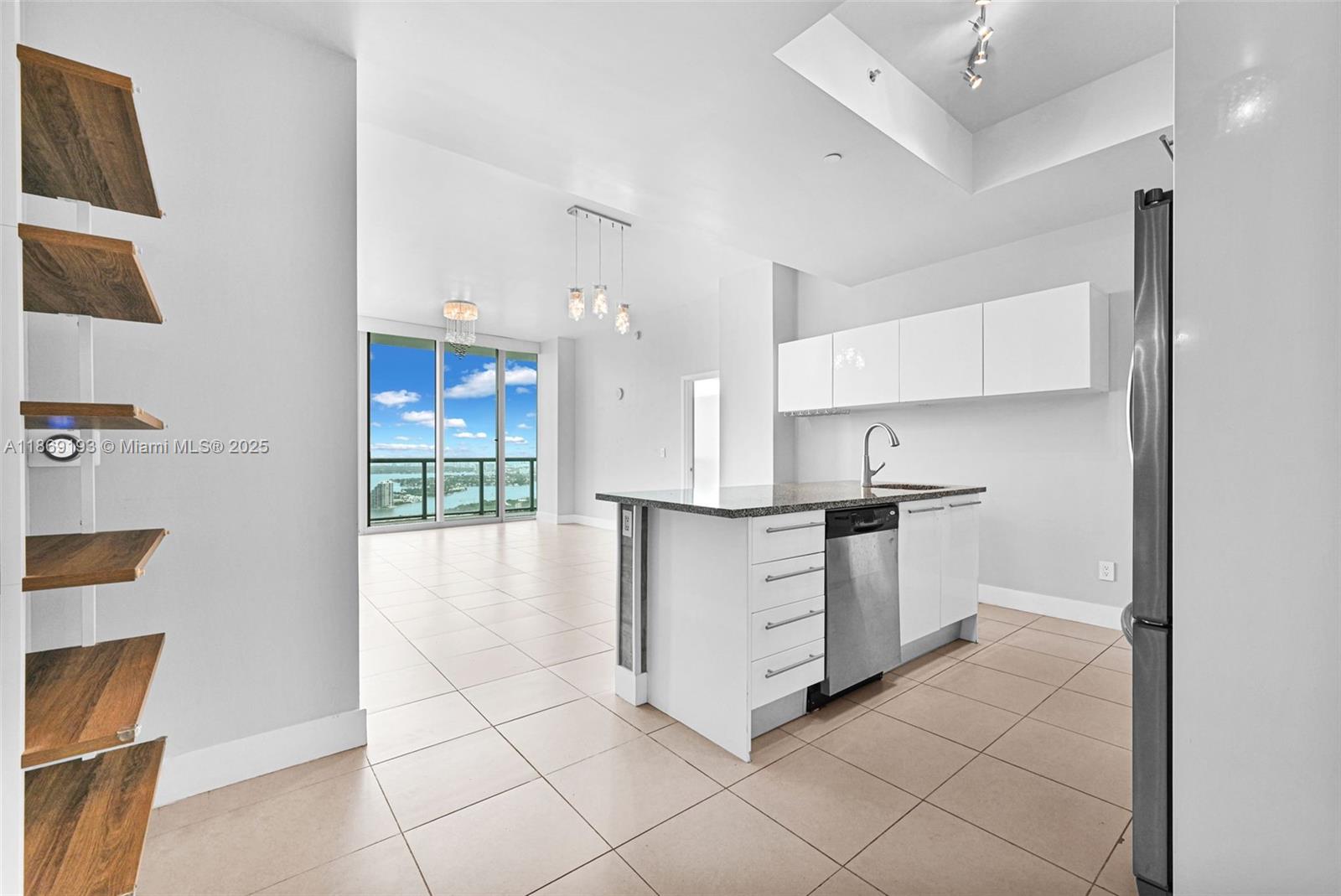 888 Biscayne Boulevard, Unit 5010 Miami, FL 33132 - Photo 3 of 18 a kitchen with white cabinets and appliances