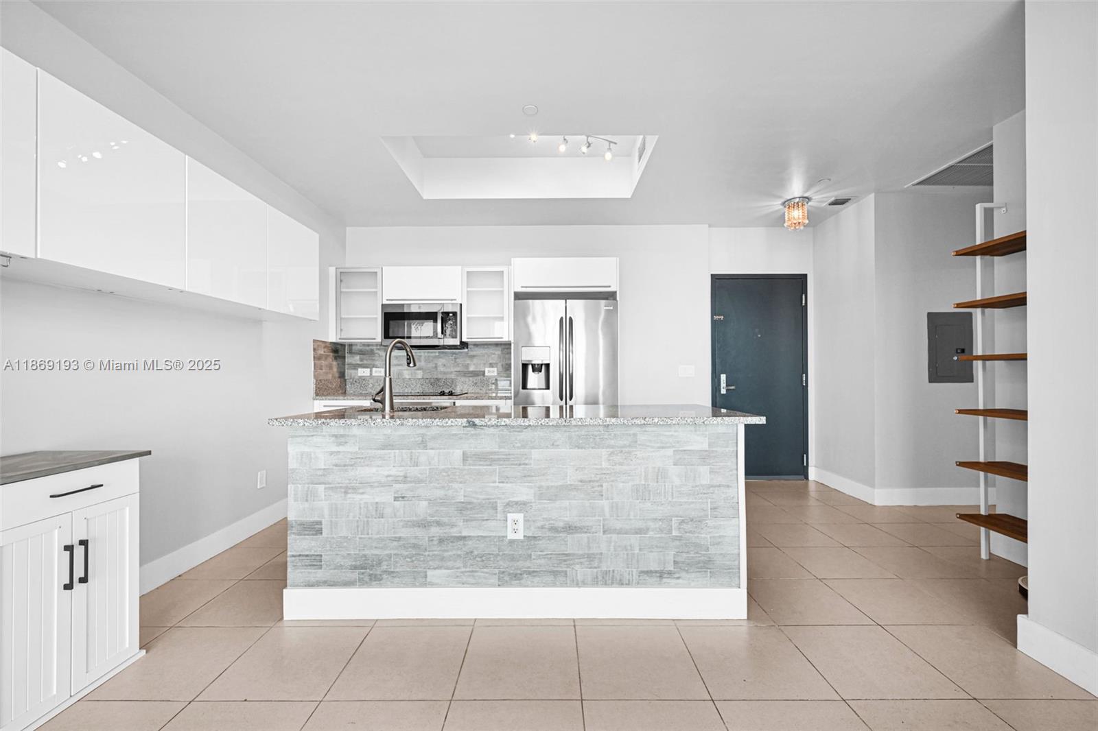 888 Biscayne Boulevard, Unit 5010 Miami, FL 33132 - Photo 5 of 18 a view of kitchen with stainless steel appliances granite countertop a stove a refrigerator a sink a counter top space and cabinets