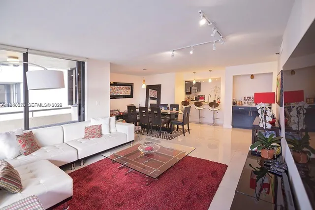 a living room with furniture hard wood floor and a table