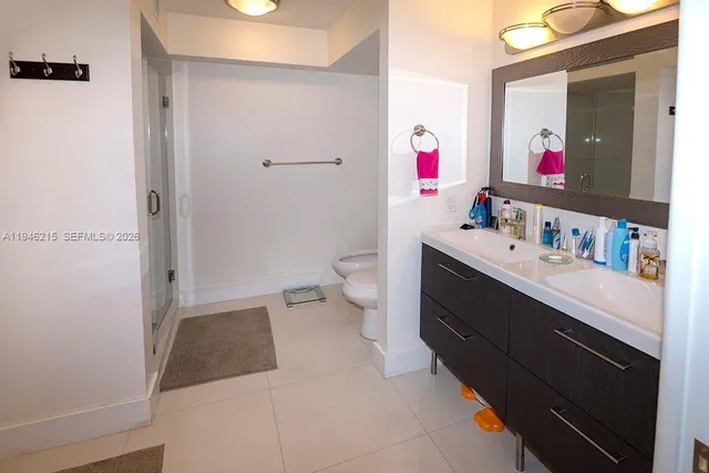 a bathroom with a sink vanity mirror and toilet