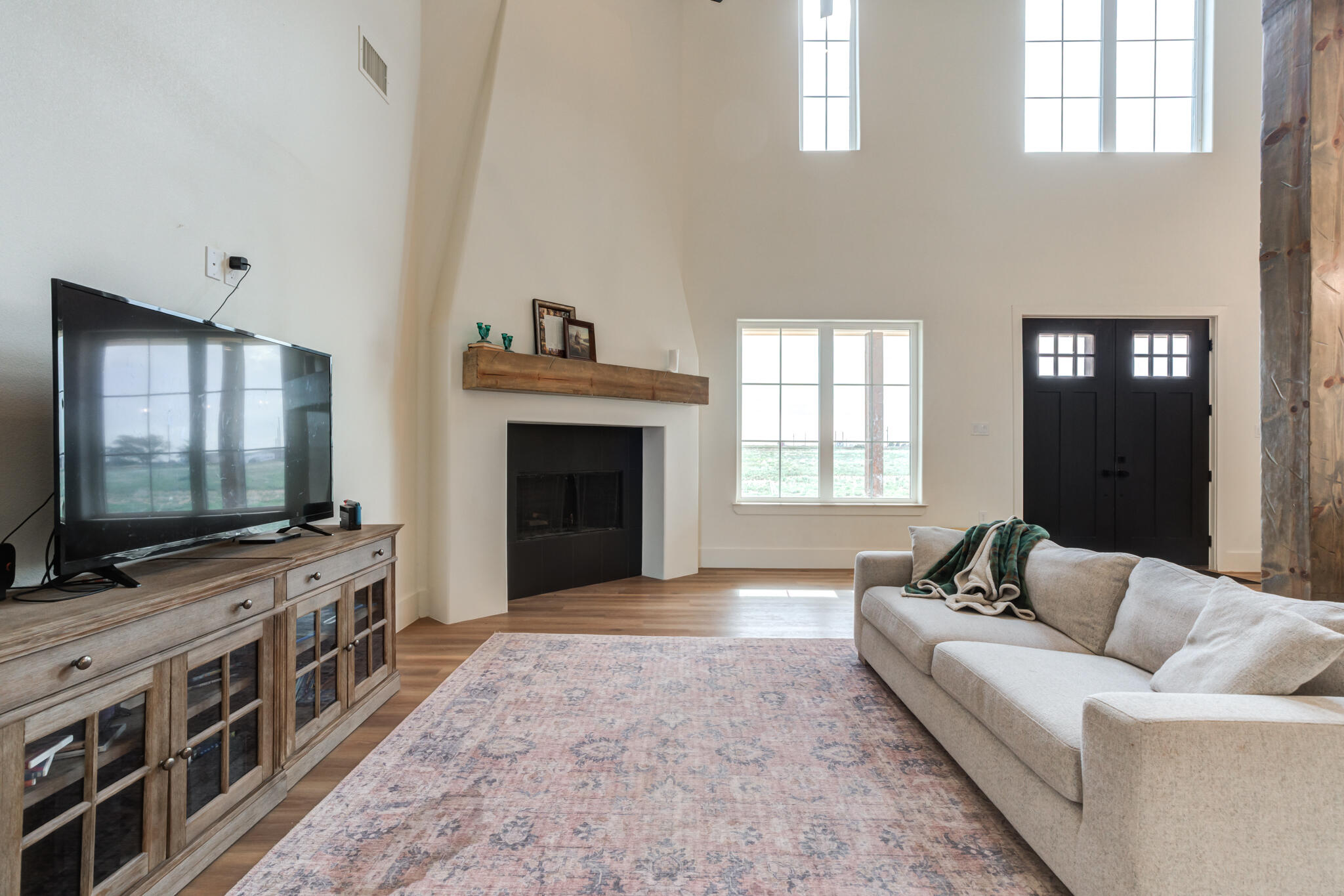 1735 Lovebird Road Lubbock, TX 79407 - Photo 15 of 44 a living room with furniture and a flat screen tv