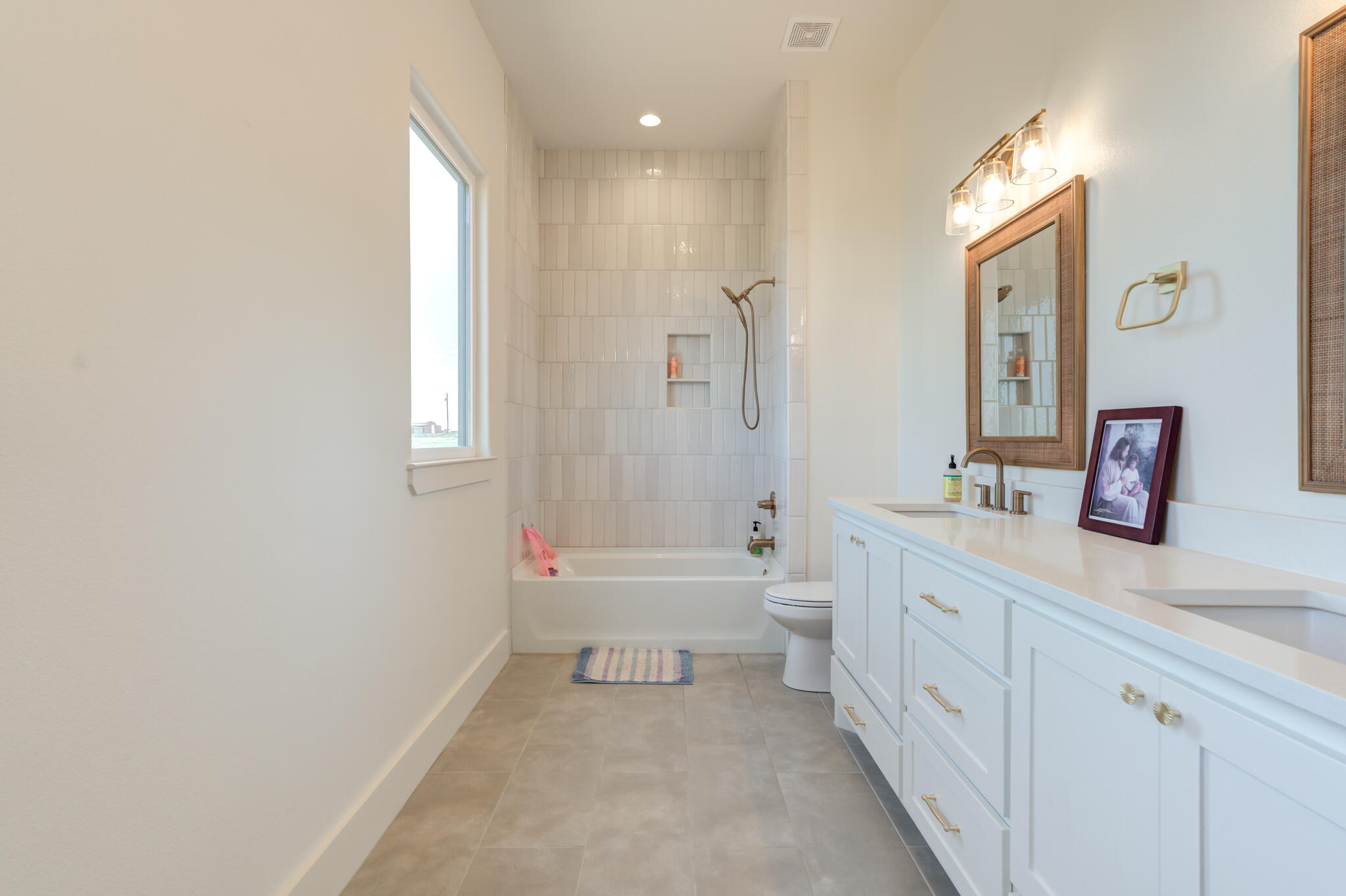 1735 Lovebird Road Lubbock, TX 79407 - Photo 32 of 44 a spacious bathroom with a toilet sink and mirror
