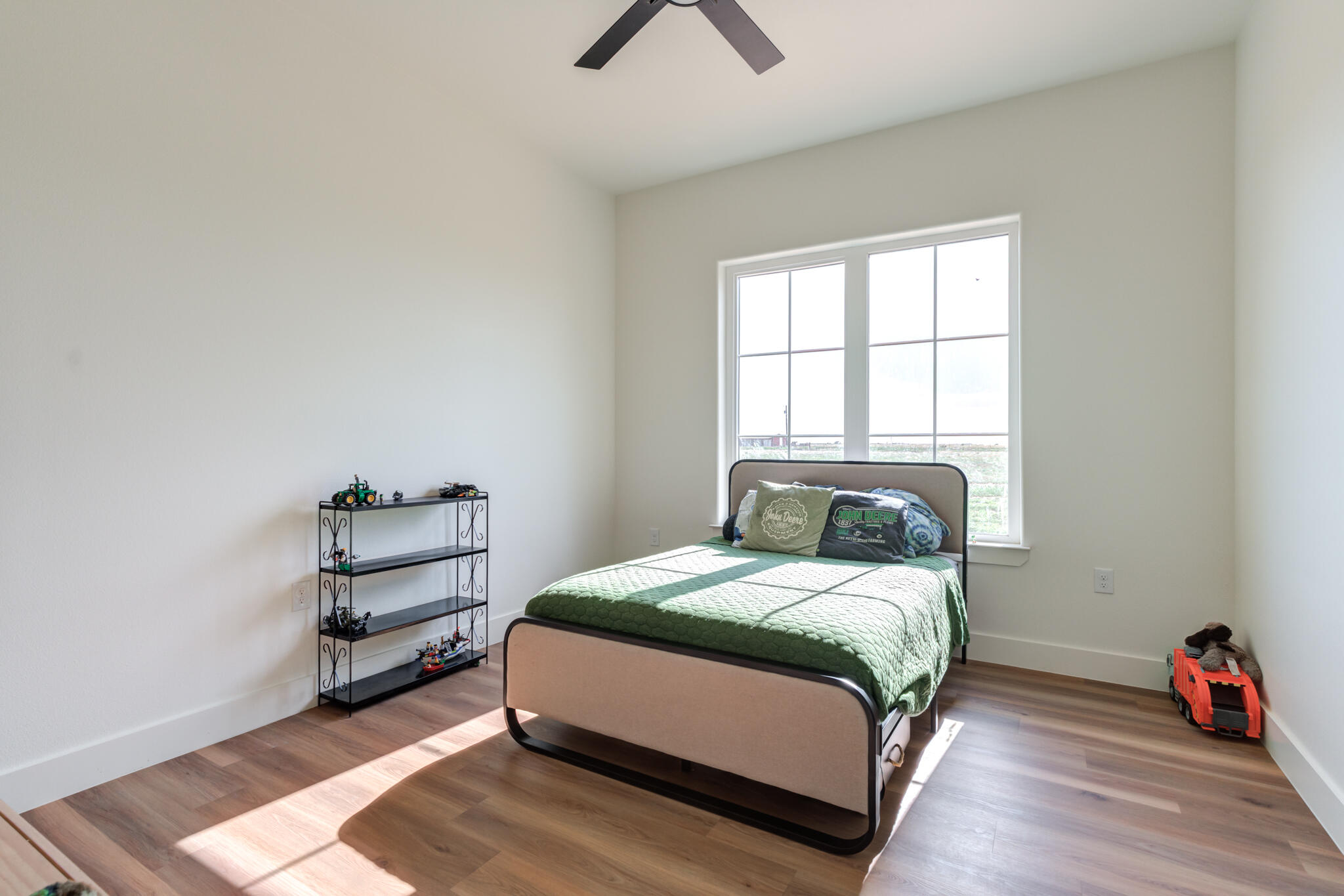 1735 Lovebird Road Lubbock, TX 79407 - Photo 33 of 44 a bedroom with a bed wooden floor and window