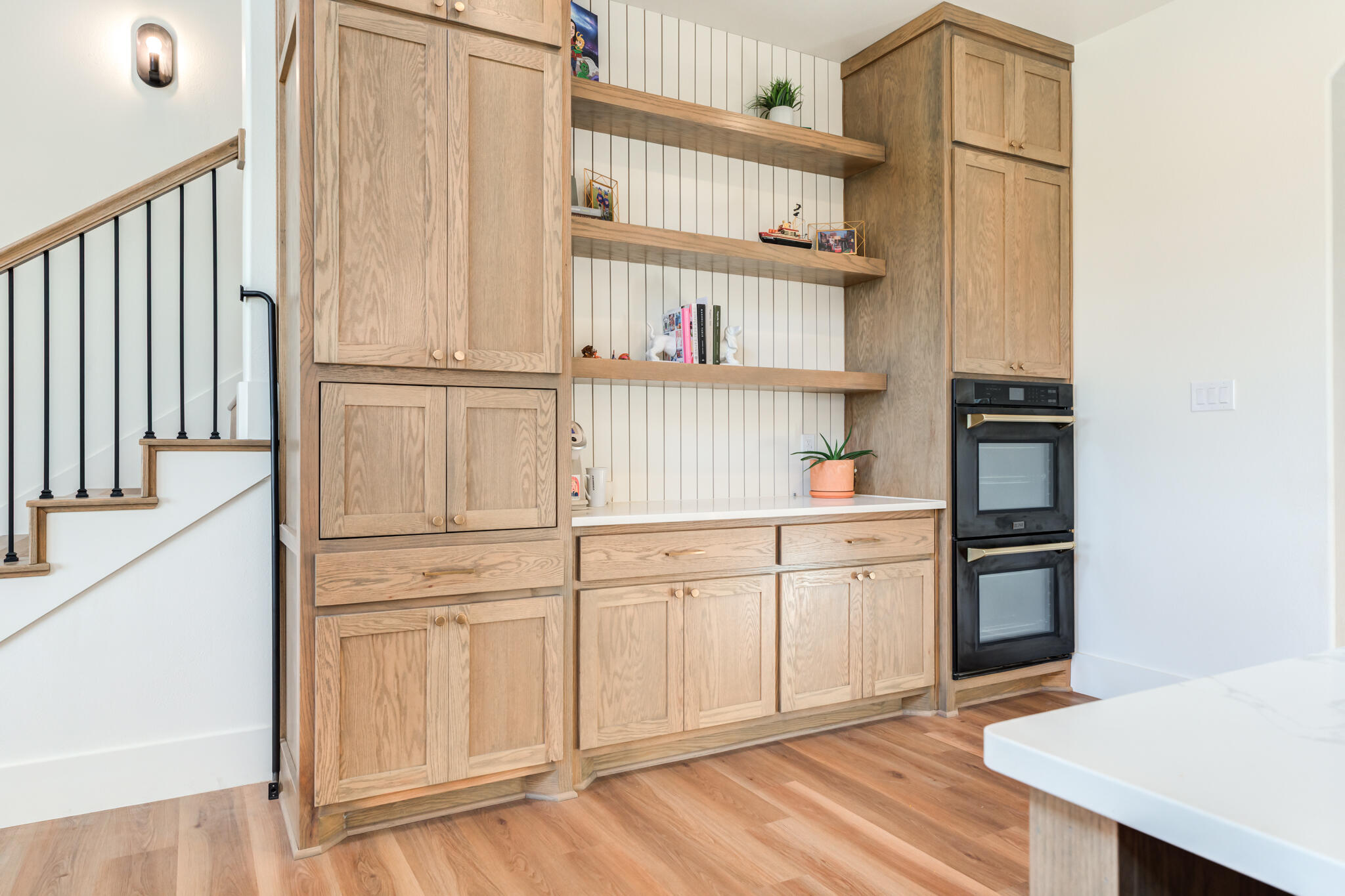 1735 Lovebird Road Lubbock, TX 79407 - Photo 8 of 44 a kitchen with white cabinets and wooden floor