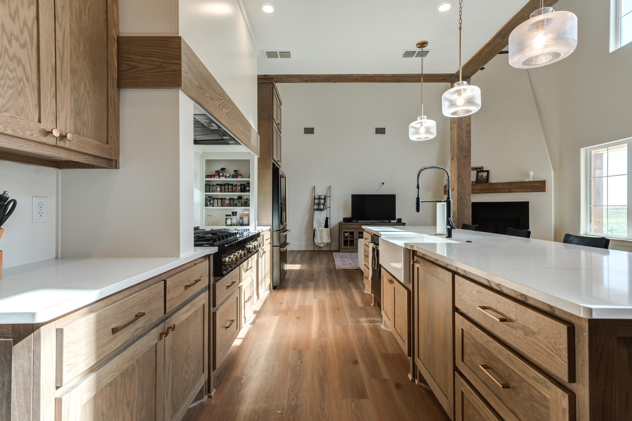 1735 Lovebird Road Lubbock, TX 79407 - Photo 10 of 44 a large kitchen with stainless steel appliances a large center island and a stove top oven
