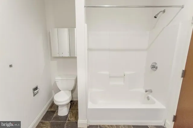 a bathroom with a bathtub and a toilet