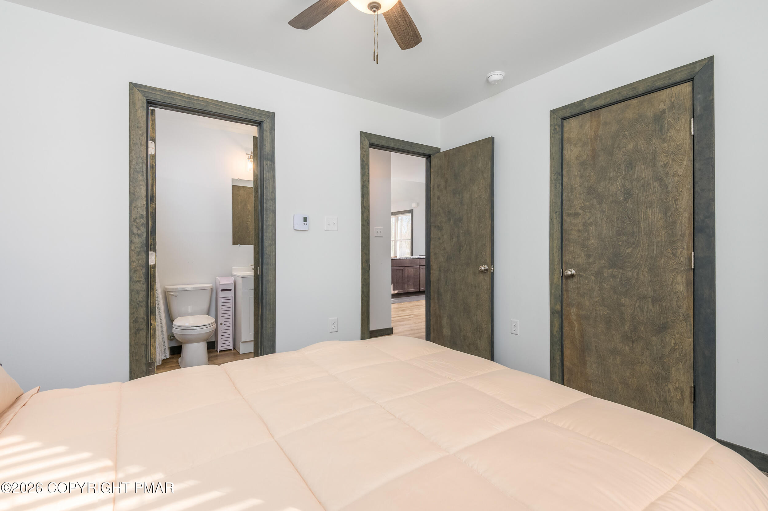 1819 Stag Run Pocono Lake, PA 18347 - Photo 13 of 40 a bedroom with a bed and a chandelier