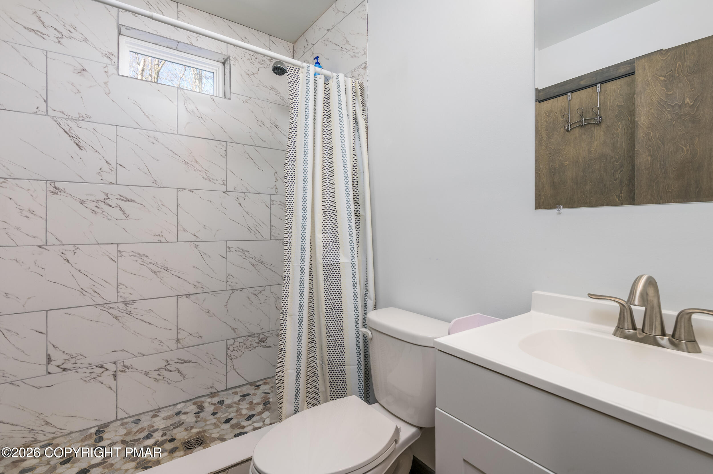 1819 Stag Run Pocono Lake, PA 18347 - Photo 16 of 40 a bathroom with a sink a toilet and shower