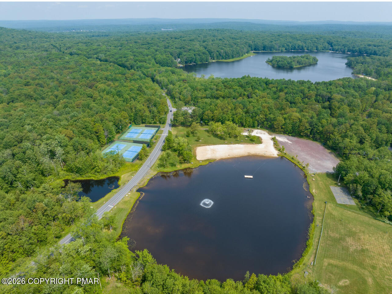 1819 Stag Run Pocono Lake, PA 18347 - Photo 39 of 40 an aerial view of a house with a yard and lake view