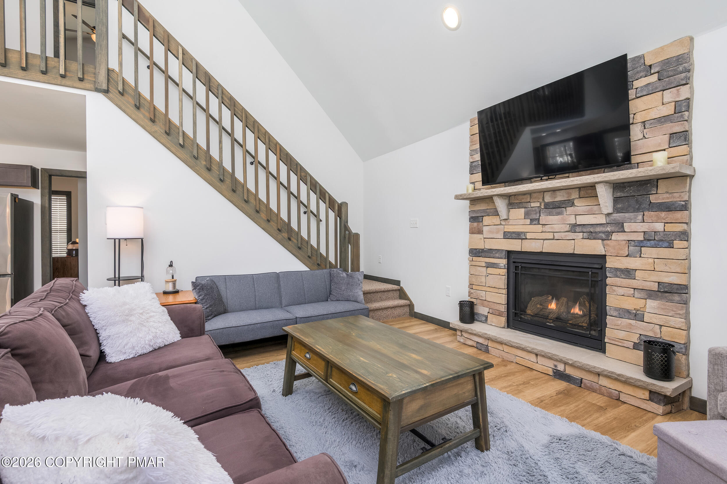 1819 Stag Run Pocono Lake, PA 18347 - Photo 4 of 40 a living room with furniture a flat screen tv and a fireplace