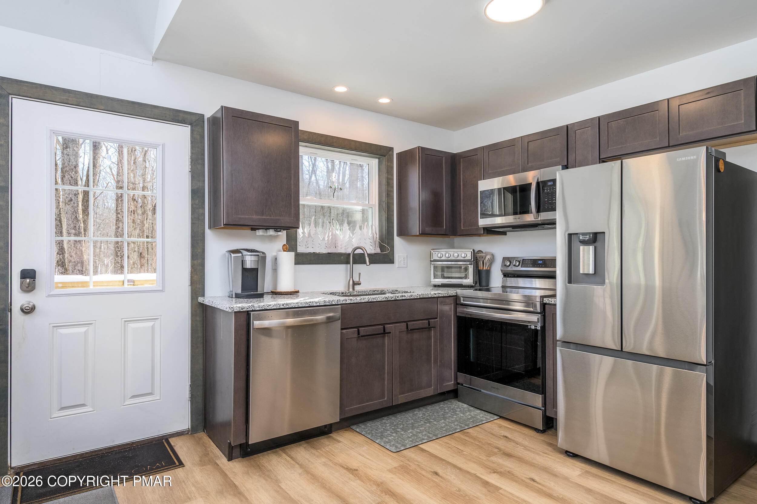 1819 Stag Run Pocono Lake, PA 18347 - Photo 9 of 40 a kitchen with stainless steel appliances granite countertop a refrigerator stove a sink and a microwave