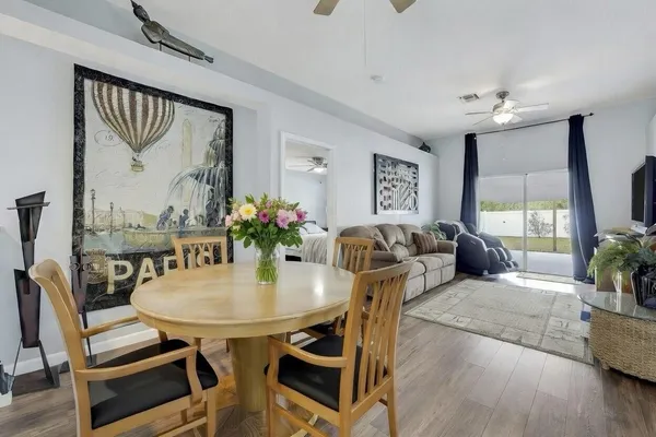 a view of a dining room with furniture window and wooden floor