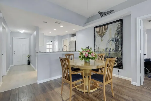 a view of a dining room with furniture and wooden floor