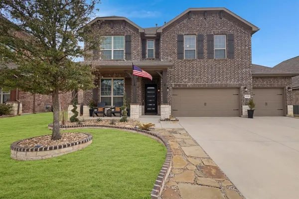 a front view of a house with a garden and plants