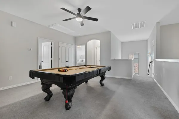 a room with pool table and windows