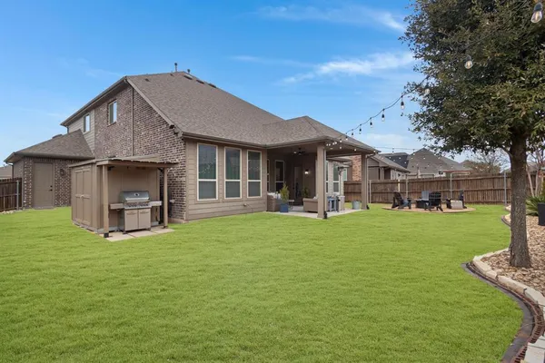 a view of a house with a yard and sitting area