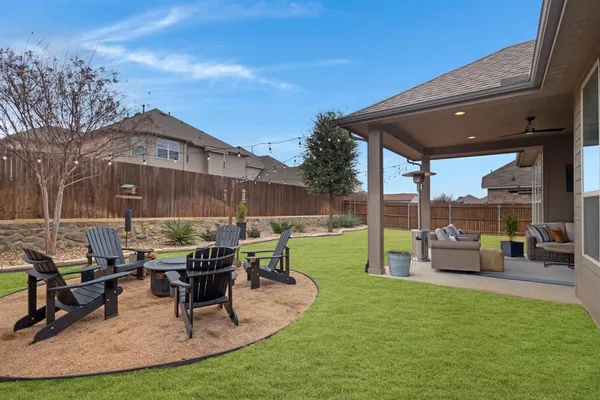 a building outdoor space with patio furniture and a garden