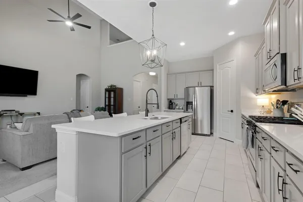 a kitchen with stainless steel appliances a sink stove and refrigerator