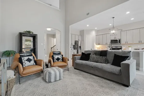a living room with furniture and kitchen view
