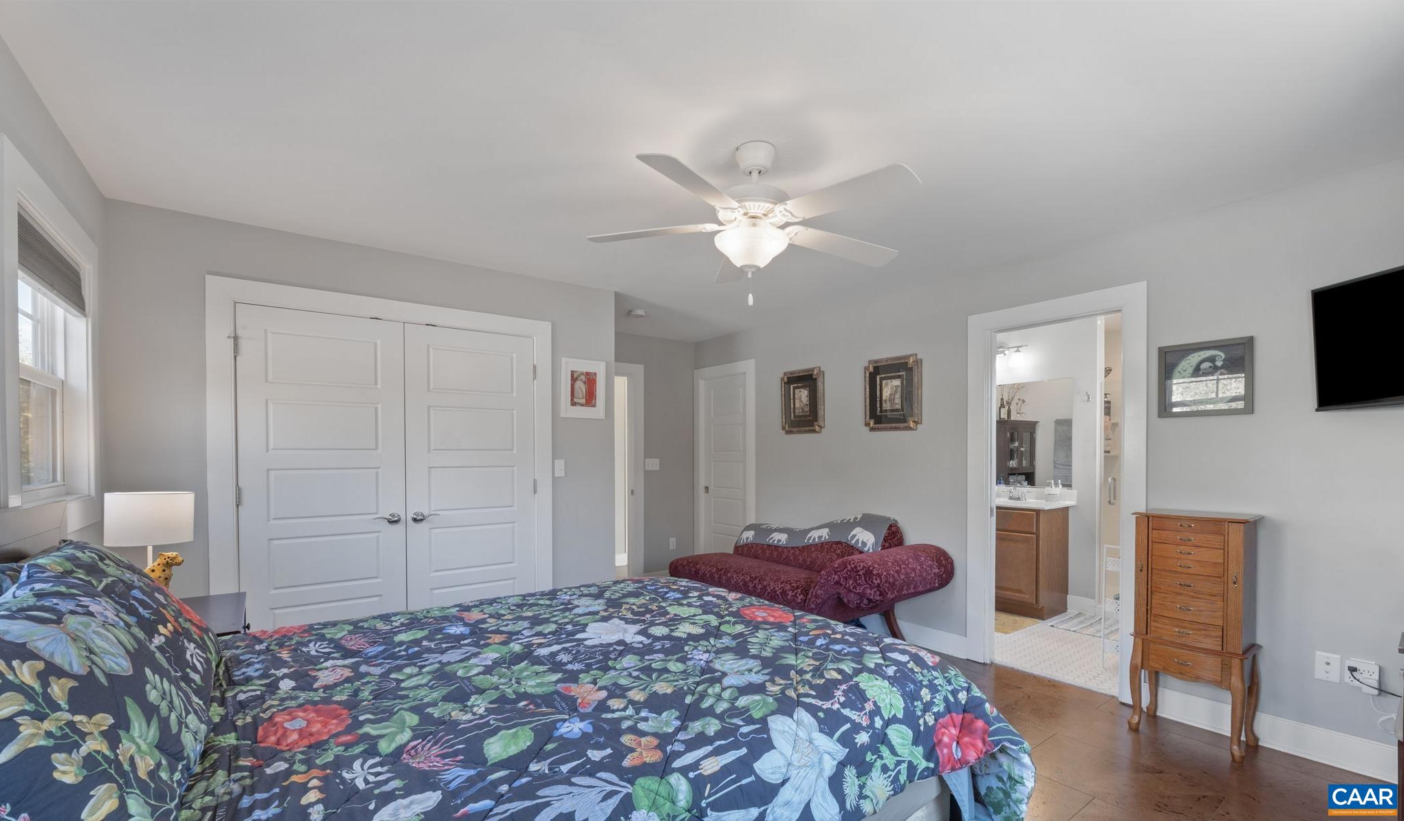 1450 Avon Street Charlottesville, VA 22902 - Photo 13 of 25 a bedroom with a bed and a chandelier