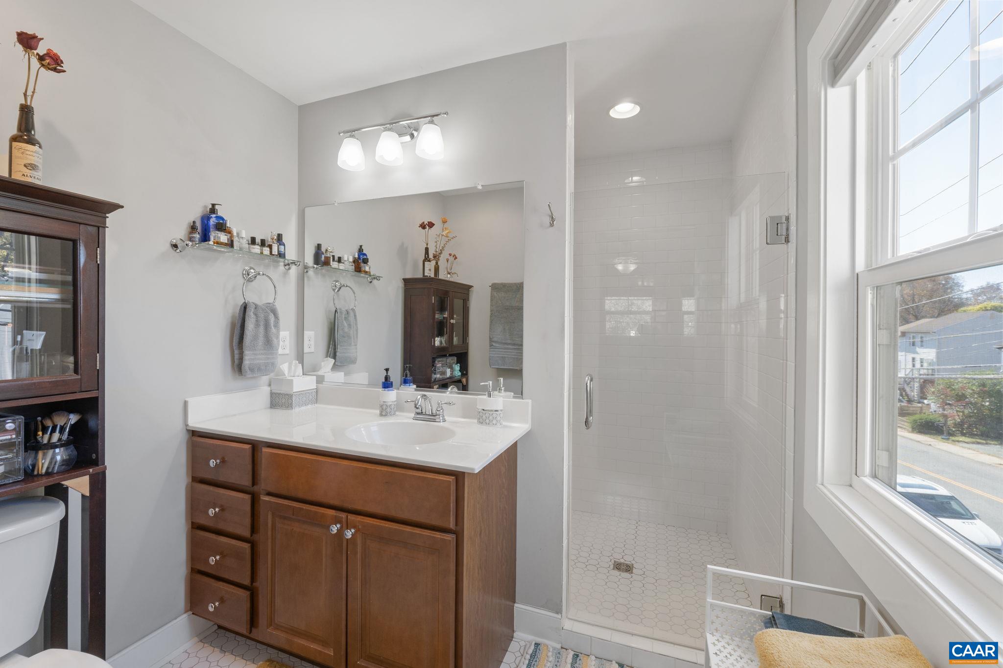 1450 Avon Street Charlottesville, VA 22902 - Photo 14 of 25 a bathroom with a sink vanity shower and a mirror