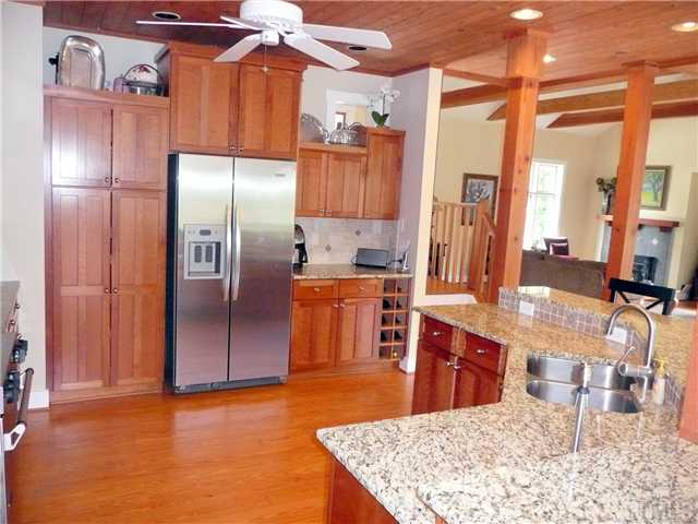 13320 Melvin Arnold Road Raleigh, NC 27613 - Photo 3 of 25 a kitchen with stainless steel appliances kitchen island granite countertop a refrigerator and microwave