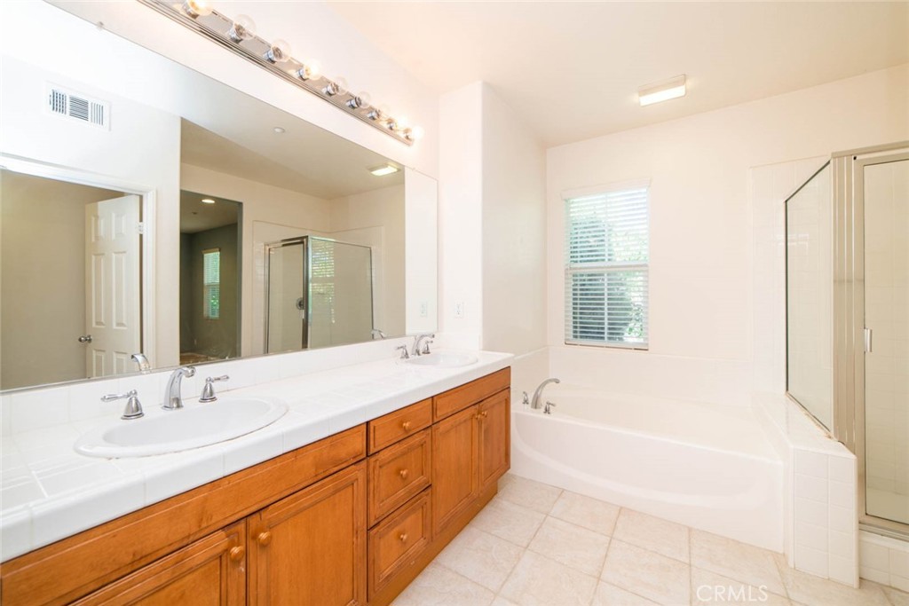 368 Quail Ridge Irvine, CA 92603 - Photo 17 of 23 a spacious bathroom with a tub sink and mirror