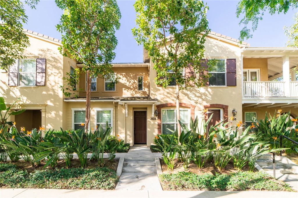 368 Quail Ridge Irvine, CA 92603 - Photo 2 of 23 a front view of a residential houses with yard and green space