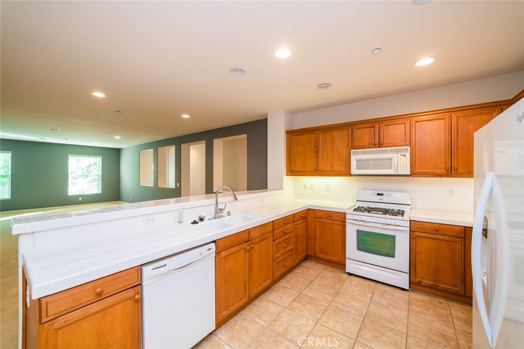 368 Quail Ridge Irvine, CA 92603 - Photo 10 of 23 a large kitchen with stainless steel appliances granite countertop a sink and cabinets