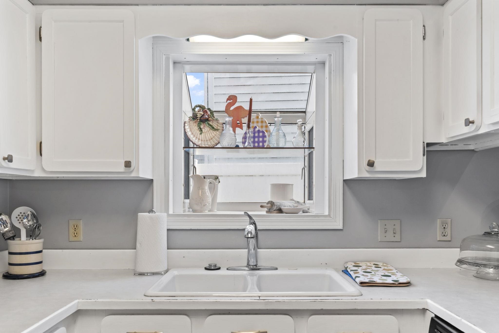 811 9th Avenue South North Myrtle Beach, SC 29582 - Photo 14 of 35 Kitchen with white cabinets and light countertops