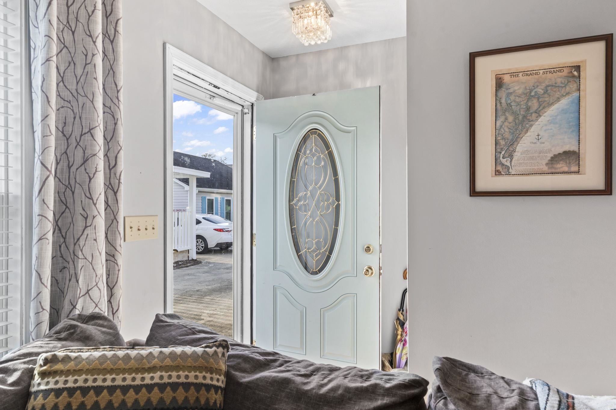811 9th Avenue South North Myrtle Beach, SC 29582 - Photo 25 of 35 Foyer entrance featuring a chandelier