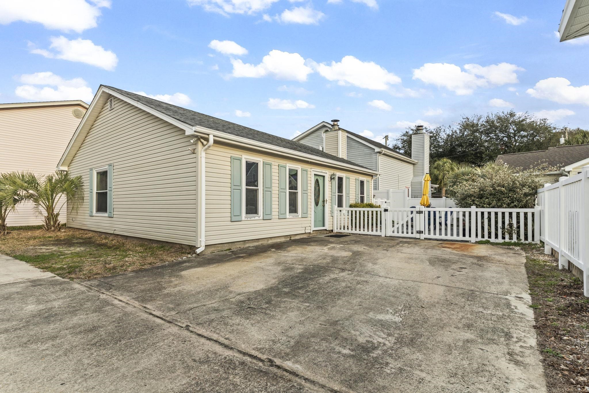 811 9th Avenue South North Myrtle Beach, SC 29582 - Photo 34 of 35 View of front of home featuring a fenced front yard, roof with shingles, a chimney, and a gate